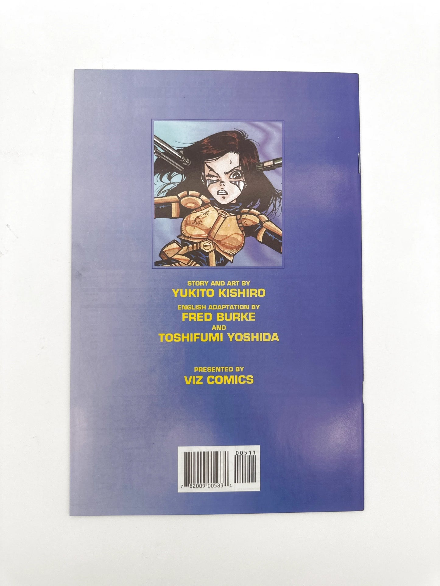 Manga book with a blue cover featuring a character in golden armor