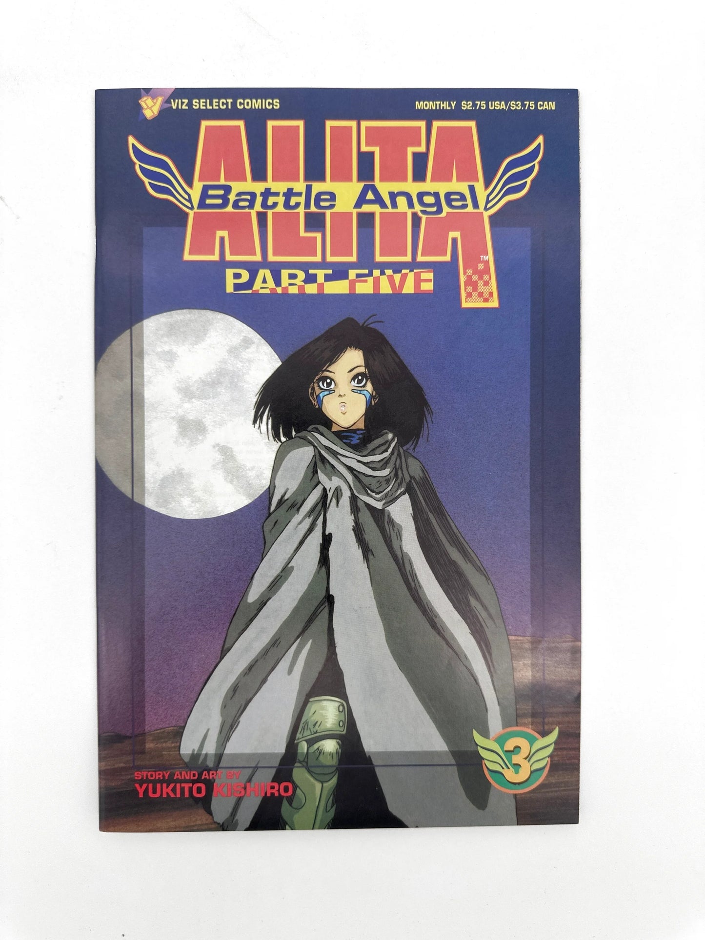 A comic book with a dark blue cover featuring a female character in a grey cloak, a large white moon, and the title ’ALITA Battle Angel PART FIVE’