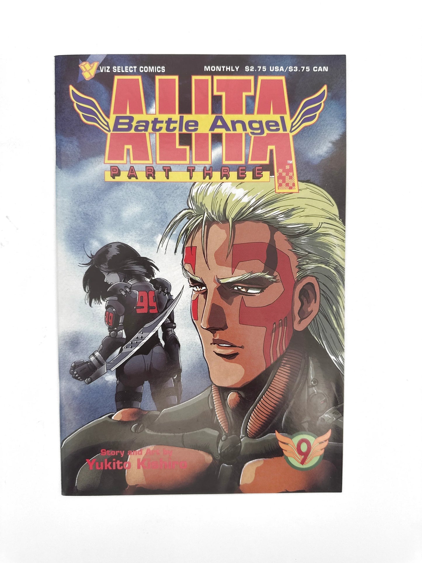 An "Alita Battle Angel Part Three" comic book, volume 9, with a man's face and a woman with a sword on the cover.