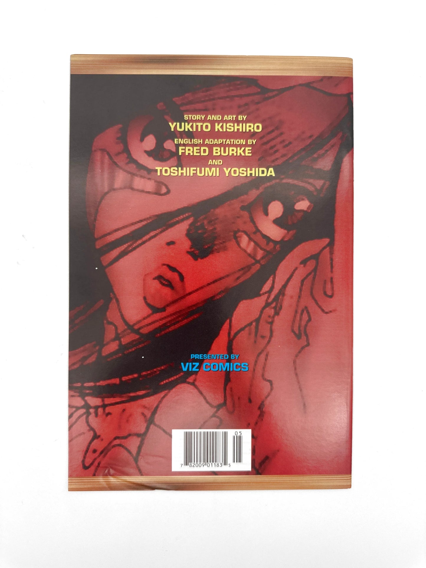 A comic book or manga with a red-toned illustration of a character's face.