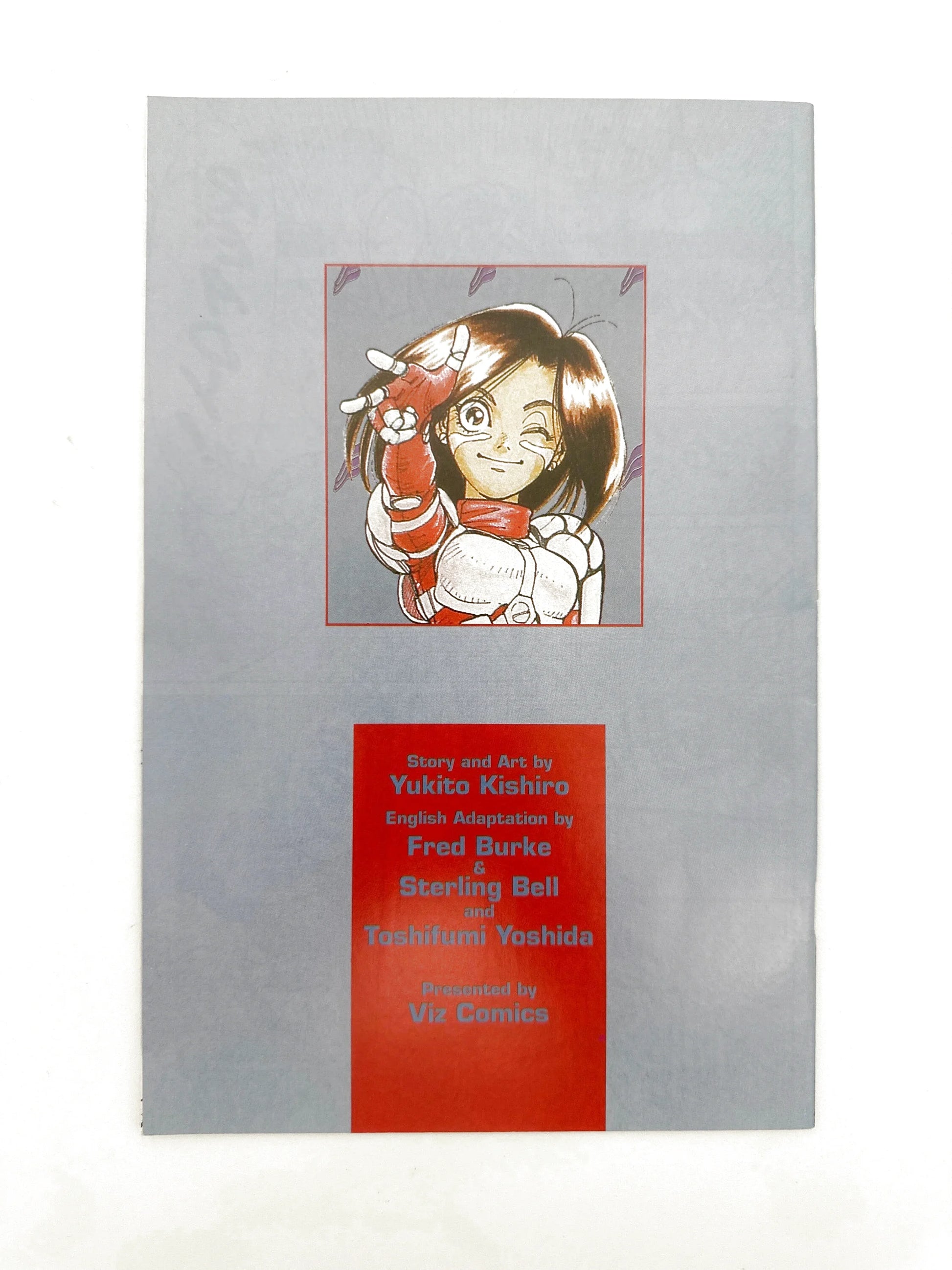 A manga book with a colorful illustration of a winking character.