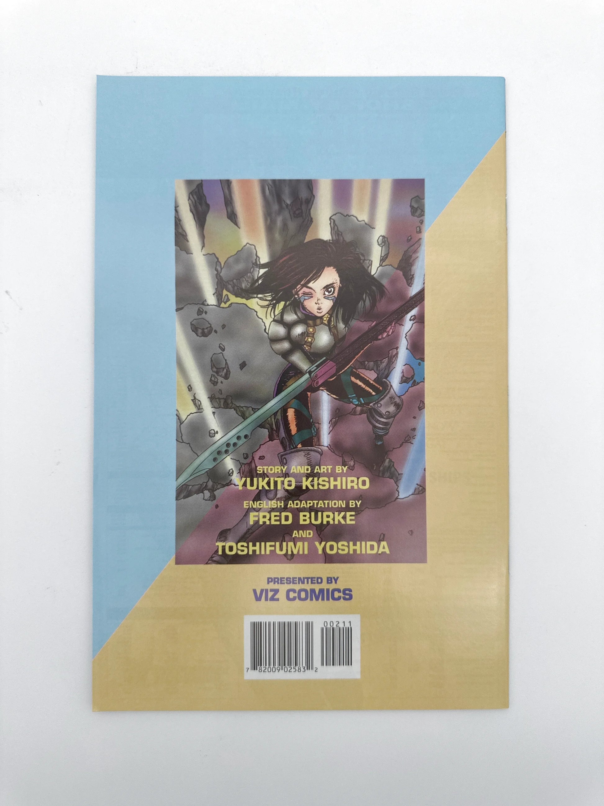 Manga comic book with a blue and yellow cover featuring a female character in armor