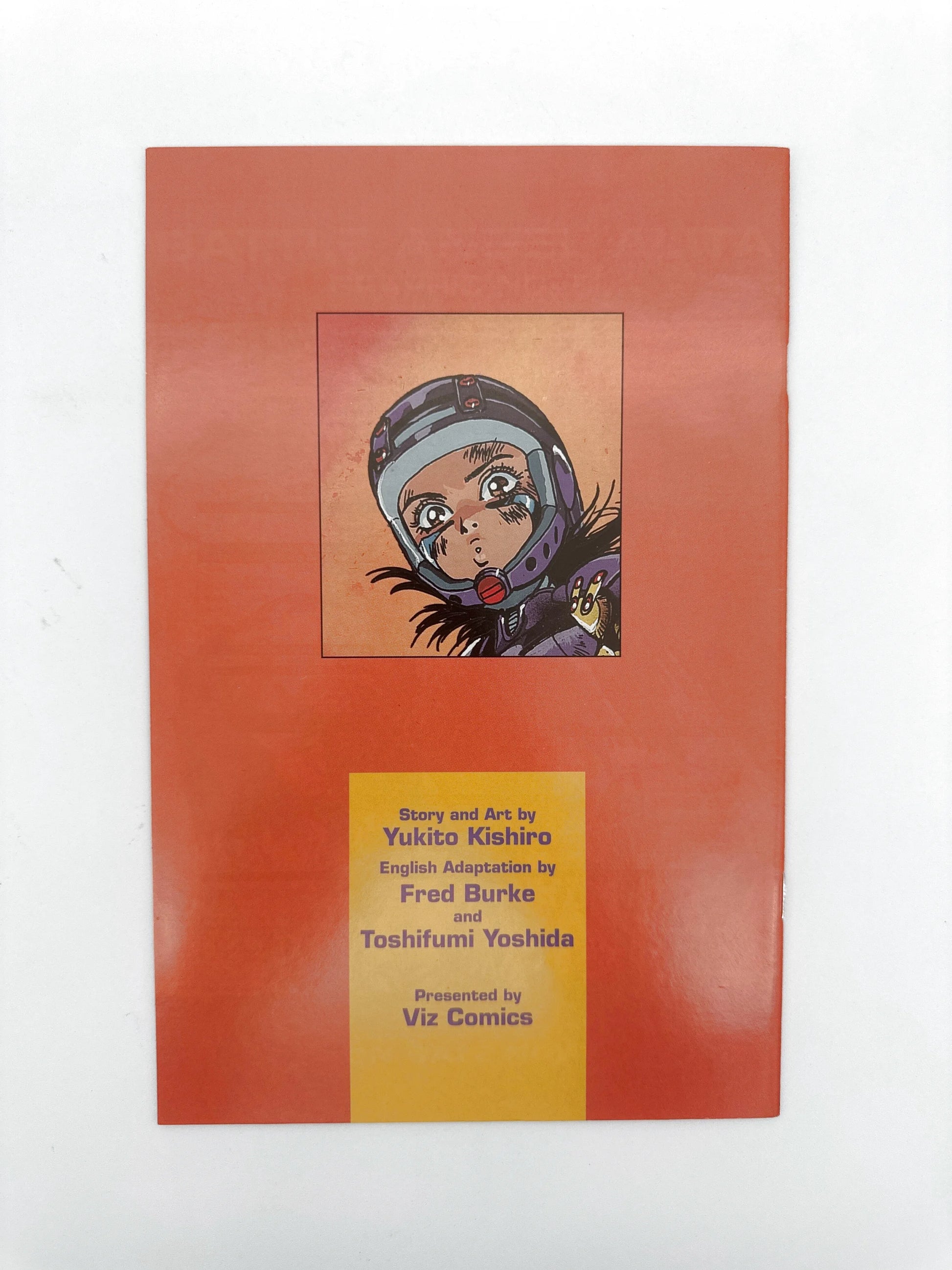 A manga comic book with an orange cover featuring a character’s face in a helmet and text detailing the story, art, and adaptation credits